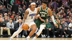 Paolo Banchero #5 of the Orlando Magic is defended by Giannis Antetokounmpo #34 of the Milwaukee Bucks during a game at Fiserv Forum on December 21, 2023 in Milwaukee, Wisconsin.