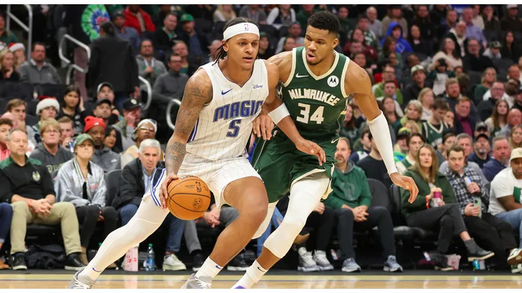 Paolo Banchero #5 of the Orlando Magic is defended by Giannis Antetokounmpo #34 of the Milwaukee Bucks during a game at Fiserv Forum on December 21, 2023 in Milwaukee, Wisconsin.