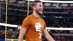 Quinn Ewers #3 of the Texas Longhorns walks across the field before the Goodyear Cotton Bowl against the Ohio State Buckeyes at AT&T Stadium on January 10, 2025 in Arlington, Texas.