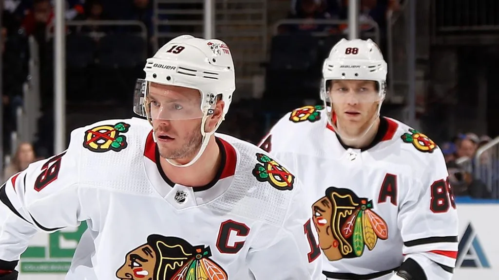 Jonathan Toews #19 and Patrick Kane #88 of the Chicago Blackhawks skates against the New York Islanders during the second period at the UBS Arena on December 04, 2022 in Elmont, New York.