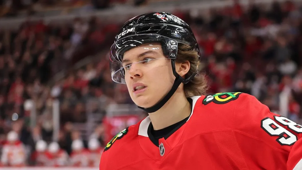 Connor Bedard #98 of the Chicago Blackhawks celebrates after scoring a goal, his 100th career point, against the Calgary Flames during the second period at the United Center on January 13, 2025 in Chicago, Illinois.