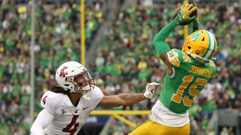 Tez Johnson #15 of the Oregon Ducks reaches up to make a catch over Kapena Gushiken #4 of the Washington State Cougars in the second half at Autzen Stadium on October 21, 2023 in Eugene, Oregon.Tez Johnson #15 of the Oregon Ducks reaches up to make a catch over Kapena Gushiken #4 of the Washington State Cougars in the second half at Autzen Stadium on October 21, 2023 in Eugene, Oregon.
