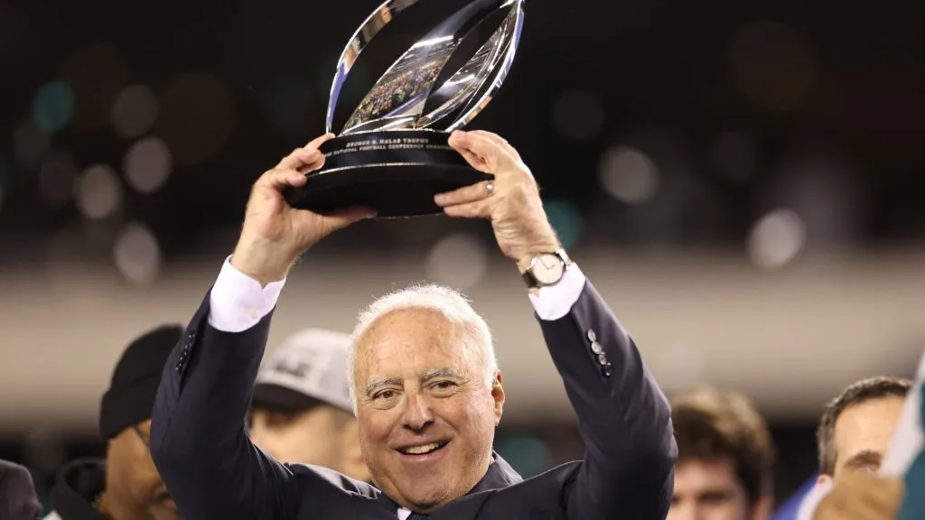 Owner Jeffrey Lurie of the Philadelphia Eagles hoist the George Halas Trophy after they defeated the San Francisco 49ers in the NFC Championship Game in 2023. (Source: Tim Nwachukwu/Getty Images)
