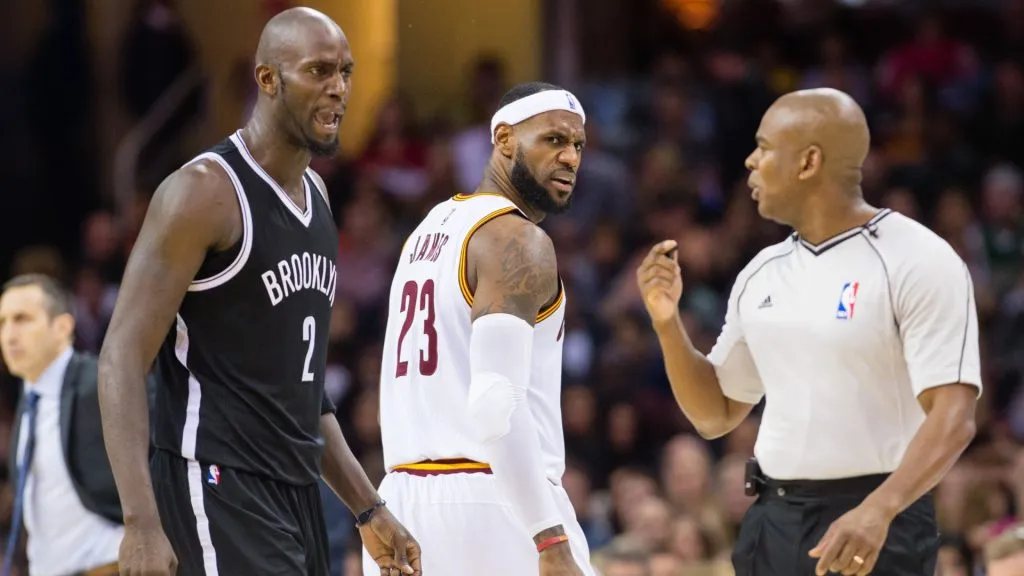 Kevin Garnett #2 of the Brooklyn Nets and LeBron James #23 of the Cleveland Cavaliers yell at official Sean Wright #65 on December 19, 2014 in Cleveland, Ohio.