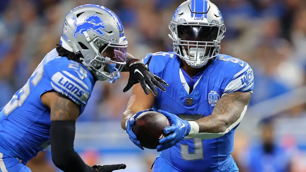 David Montgomery #5 hands the ball off to Jahmyr Gibbs #26 during the second quarter of a game against the Chicago Bears at Ford Field on November 19, 2023. (Source: Rey Del Rio/Getty Images)