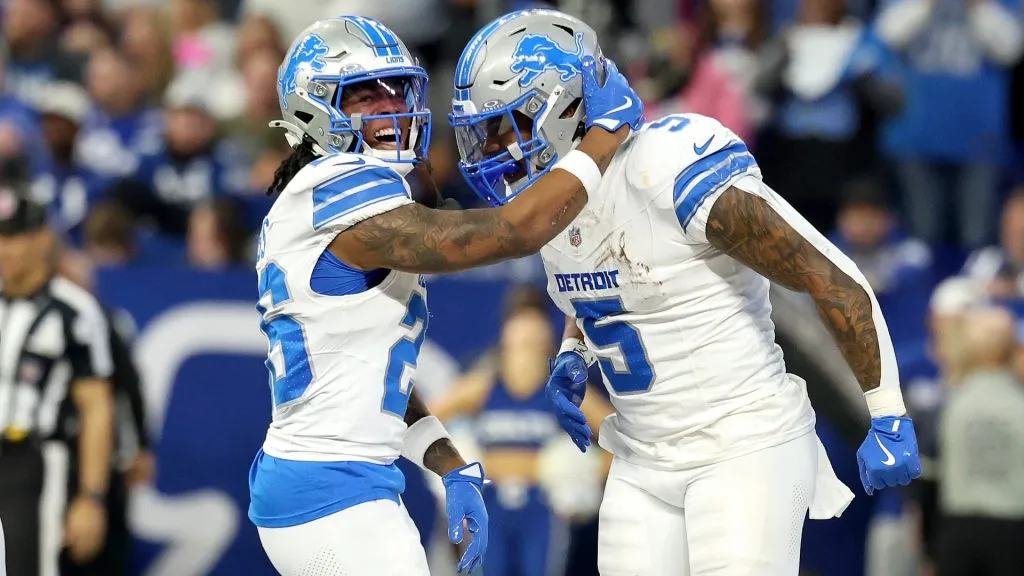 Jahmyr Gibbs #26 and David Montgomery #5 of the Detroit Lions celebrate a touchdown against the Indianapolis Colts at Lucas Oil Stadium on November 24, 2024. (Source: Andy Lyons/Getty Images)