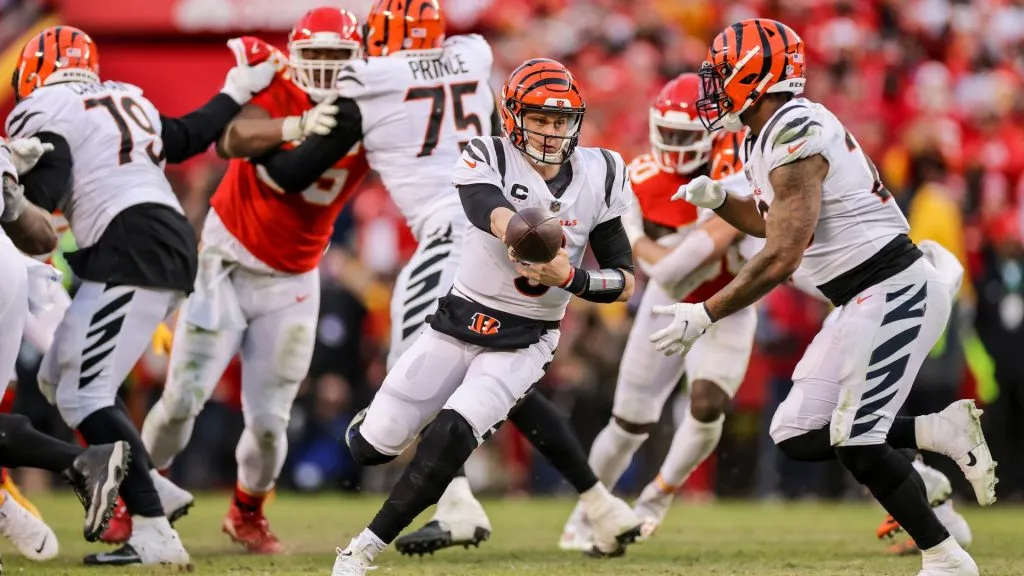 Joe Burrow #9 of the Cincinnati Bengals turns to hand off the football during overtime of the AFC Championship Game against the Kansas City Chiefs, in 2022.