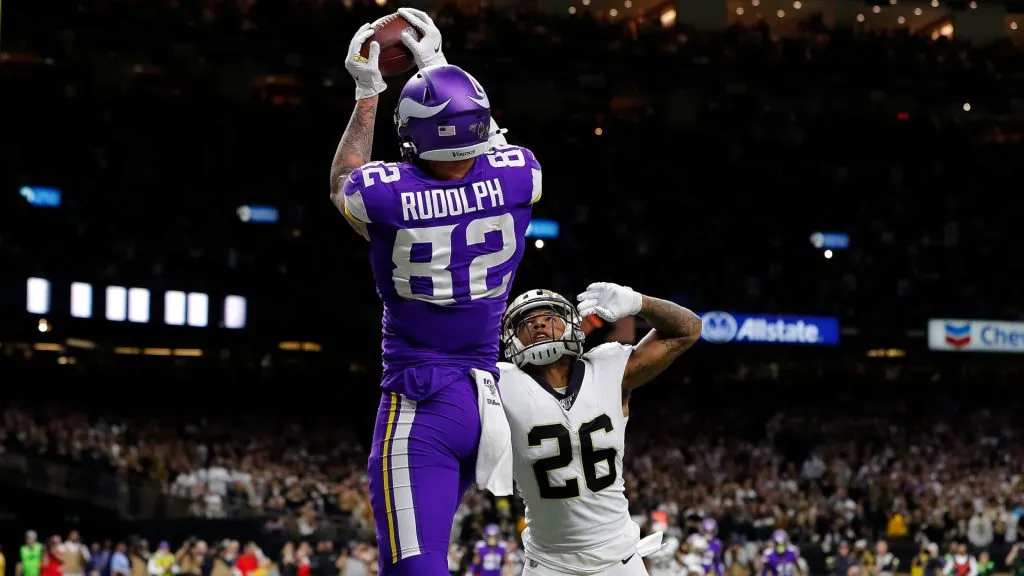 Kyle Rudolph #82 of the Minnesota Vikings makes the game-winning touchdown reception against P.J. Williams #26 of the New Orleans Saints during overtime in the NFC Wild Card Playoff game