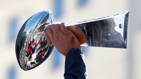 Andrew Whitworth #77 of the Los Angeles Rams raises the Vince Lombardi trophy during the Los Angeles Rams Super Bowl LVI victory parade on February 16, 2022 in Los Angeles, California. (Photo by Ronald Martinez/Getty Images)