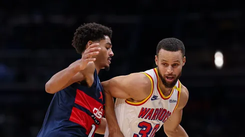 Stephen Curry #30 of the Golden State Warriors brings the ball up court against Jordan Poole #13 of the Washington Wizards