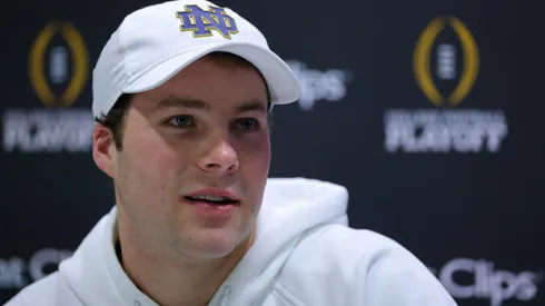 Riley Leonard #13 of the Notre Dame Fighting Irish speaks to the media during the Notre Dame Fighting Irish media day at the Georgia World Congress Center prior to the 2025 CFP National Championship between the Ohio State Buckeyes and Notre Dame Fighting Irish on January 18, 2025 in Atlanta, Georgia.