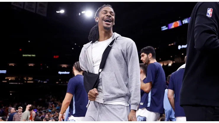Ja Morant #12 of the Memphis Grizzlies reacts after Devin Booker #1 of the Phoenix Suns missed a free throw during the second half at Footprint Center on January 07, 2024 in Phoenix, Arizona.