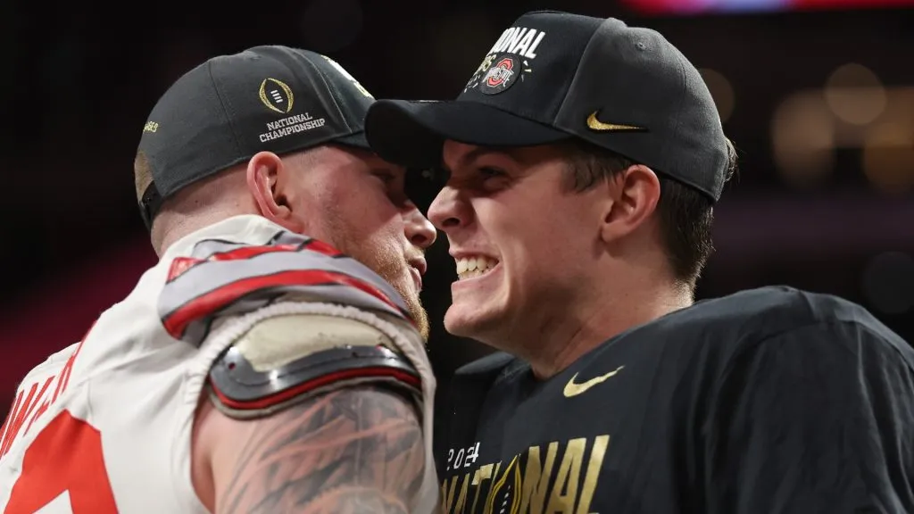 Jack Sawyer #33 and Will Howard #18 of the Ohio State Buckeyes celebrate after defeating the Notre Dame Fighting Irish 34-23 in the 2025 CFP National Championship at the Mercedes-Benz Stadium on January 20, 2025 in Atlanta, Georgia.