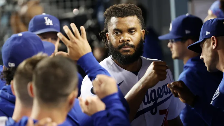 Teammates greet Kenley Jansen #74 of the Los Angeles Dodgers in the dugout after the top of the ninth inning against the St. Louis Cardinals during the National League Wild Card Game at Dodger Stadium on October 06, 2021 in Los Angeles, California.
