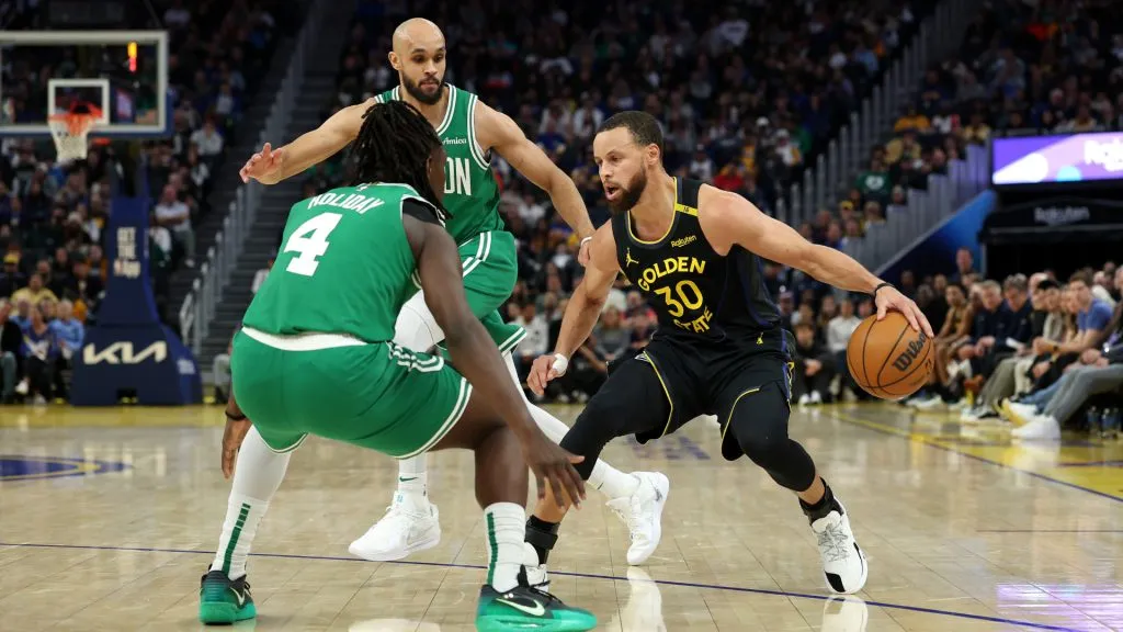 Stephen Curry #30 of the Golden State Warriors is guarded by Jrue Holiday #4 and Derrick White #9 of the Boston Celtics during the second half at Chase Center. (Ezra Shaw/Getty Images)