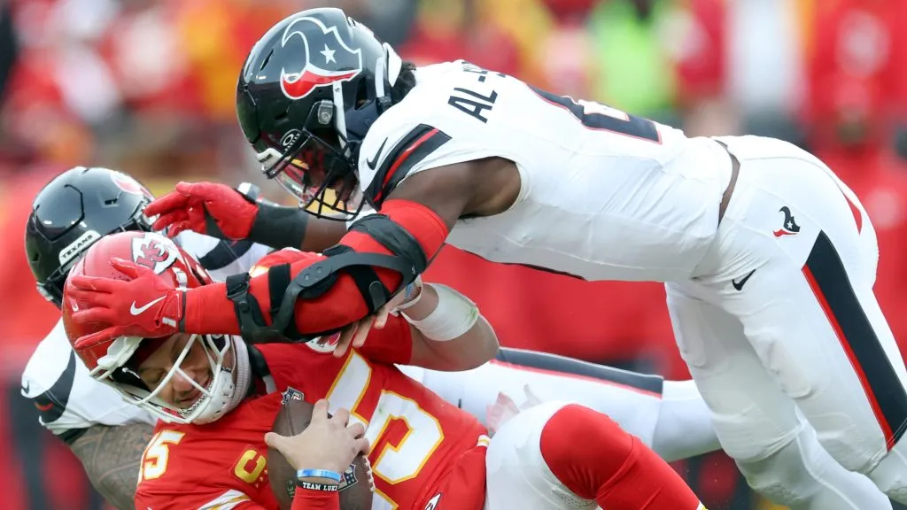 Patrick Mahomes #15 of the Kansas City Chiefs is tackled by Azeez Al-Shaair #0 of the Houston Texans during the first quarter in the AFC Divisional Playoff at GEHA Field at Arrowhead Stadium on January 18, 2025 in Kansas City, Missouri.