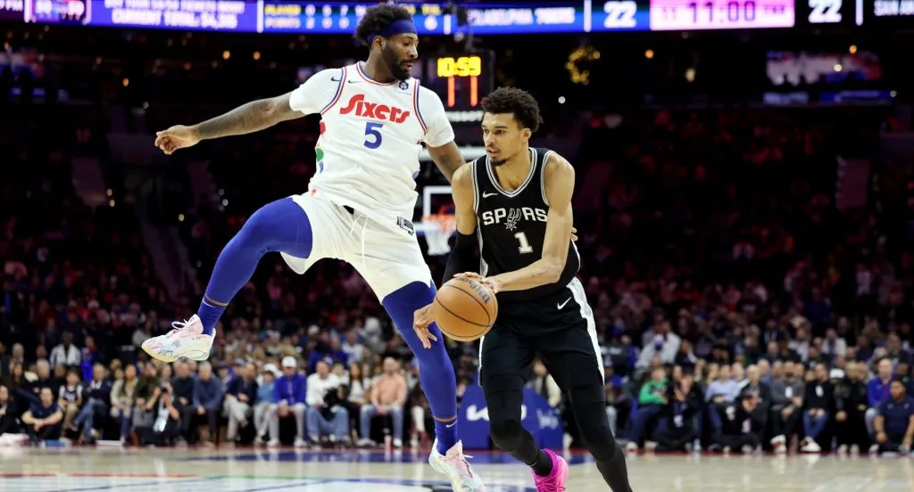 Andre Drummond #5 of the Philadelphia 76ers jumps to guard Victor Wembanyama #1 of the San Antonio Spurs.