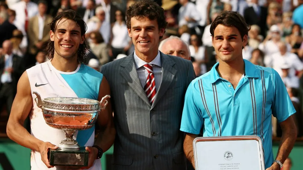 Rafael Nadal poses with the Philippe Chatrier Trophy after winning against Roger Federer and former winner Gustavo Kuerten. (Clive Brunskill/Getty Images)