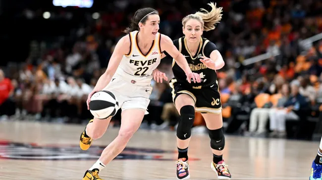 Caitlin Clark of the Indiana Fever handles the ball against Karlie Samuelson of the Washington Mystics (Greg Fiume/Getty Images)