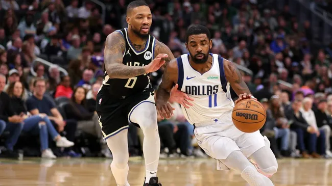 Kyrie Irving #11 of the Dallas Mavericks is defended by Damian Lillard #0 of the Milwaukee Bucks during the second half of a game at Fiserv Forum. (Stacy Revere/Getty Images)