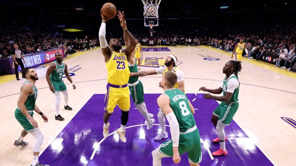 LeBron James #23 of the Los Angeles Lakers scores in front of Kristaps Porzingis #8 of the Boston Celtics during a 117-96 Lakers win at Crypto.com Arena. (Harry How/Getty Images)