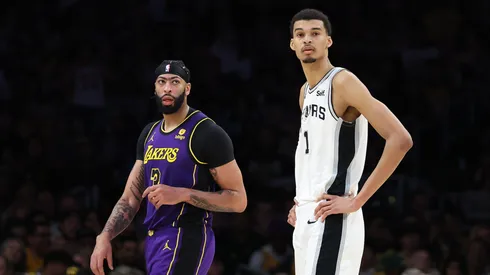 Victor Wembanyama #1 of the San Antonio Spurs stands next to Anthony Davis #3 of the Los Angeles Lakers during the second half of a game at Crypto.com Arena.