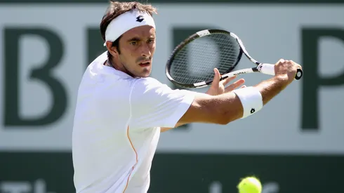 Potito Starace of Italy returns a shot to Donald Young of the USA during the BNP Paribas Open at the Indian Wells Tennis Garden
