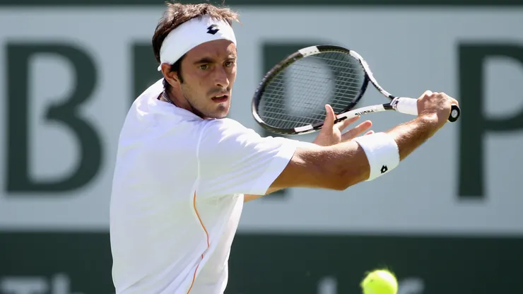Potito Starace of Italy returns a shot to Donald Young of the USA during the BNP Paribas Open at the Indian Wells Tennis Garden