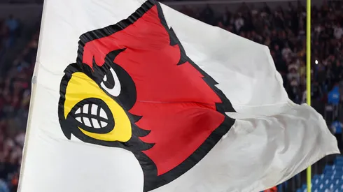 The Louisville Cardinals logo is shown on a flag before the Florida State Seminoles take on the Louisville Cardinals during the ACC Championship at Bank of America Stadium on December 2, 2023 in Charlotte, North Carolina.