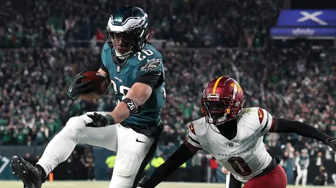 Saquon Barkley #26 of the Philadelphia Eagles scores a touchdown against Mike Sainristil #0 of the Washington Commanders