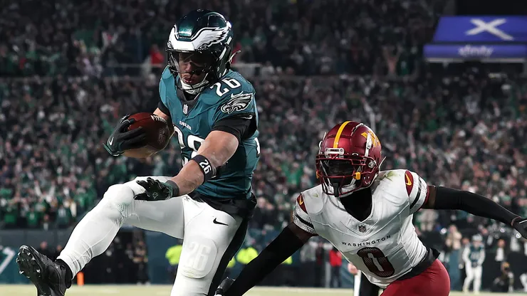Saquon Barkley #26 of the Philadelphia Eagles scores a touchdown against Mike Sainristil #0 of the Washington Commanders