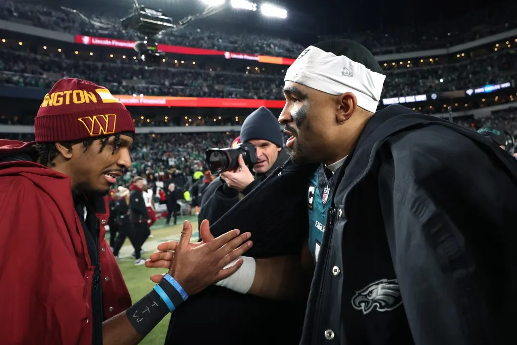 Jayden Daniels #5 of the Washington Commanders shakes hands with Jalen Hurts #1 of the Philadelphia Eagles