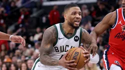 Damian Lillard #0 of the Milwaukee Bucks drives to the basket between Terance Mann #14 ad Nicolas Batum #33 of the LA Clippers