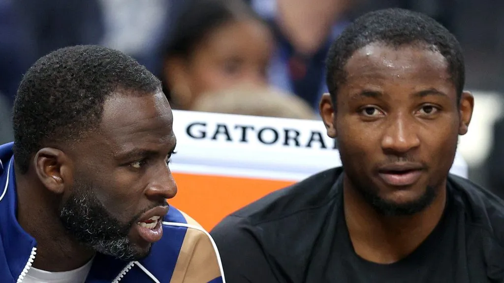 Draymond Green #23 (left) speaks to Jonathan Kuminga #00 of the Golden State Warriors