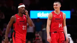 Jimmy Butler #22 and Tyler Herro #14 of the Miami Heat react against the Dallas Mavericks during overtime at Kaseya Center.