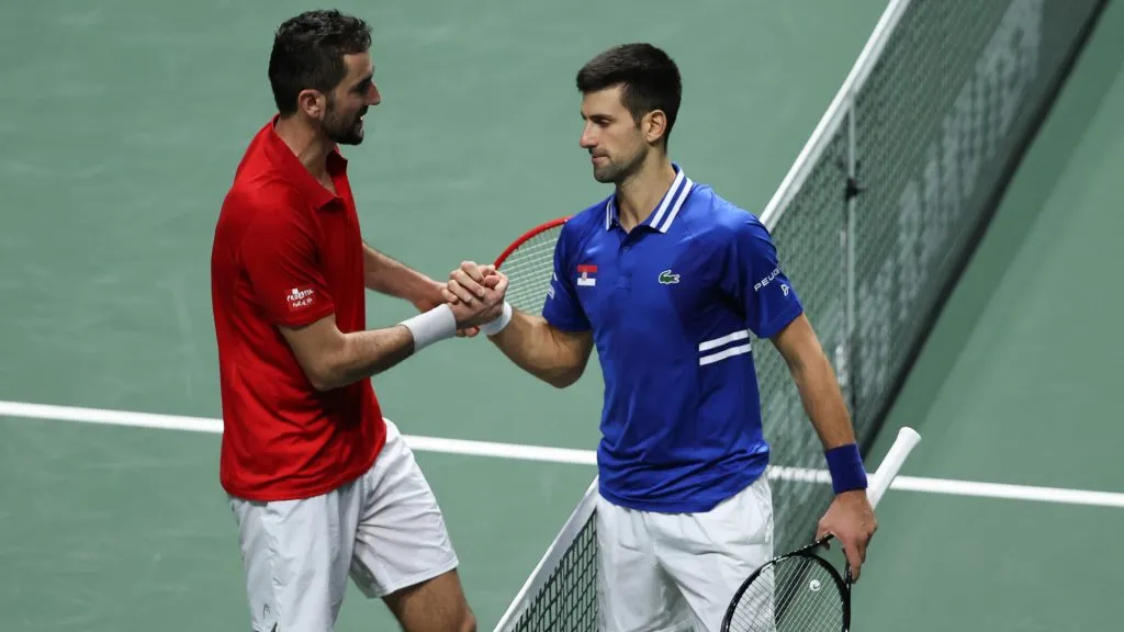 Winner Novak Djokovic and Marin Cilic embrace at the net at the end of their Davis Cup semi final between Serbia and Croatia. (Clive Brunskill/Getty Images)