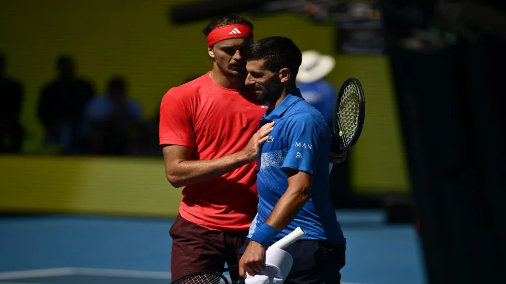 Novak Djokovic of Serbia is embraced by Alexander Zverev of Germany after retiring from the Men's Singles Semifinal during day 13 of the 2025 Australian Open at Melbourne Park on January 24, 2025 in Melbourne, Australia.