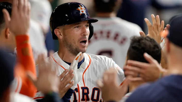 Alex Bregman #2 of the Houston Astros is congratulated in the dugout by teammates after hitting a solo home run in the first inning against the Seattle Mariners at Minute Maid Park on September 24, 2024 in Houston, Texas.