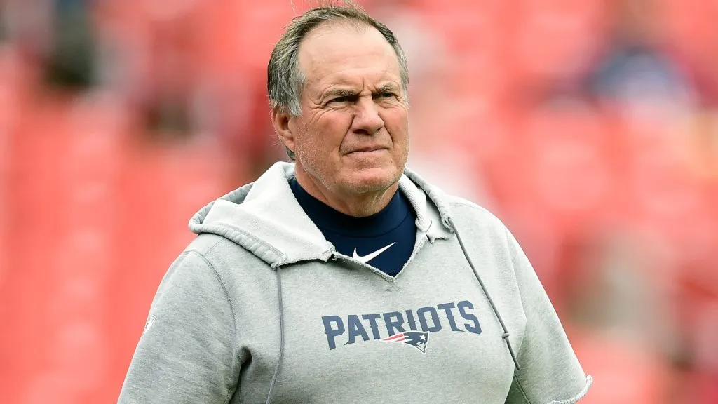 Former New England Patriots head coach Bill Belichick looks on during an NFL game.