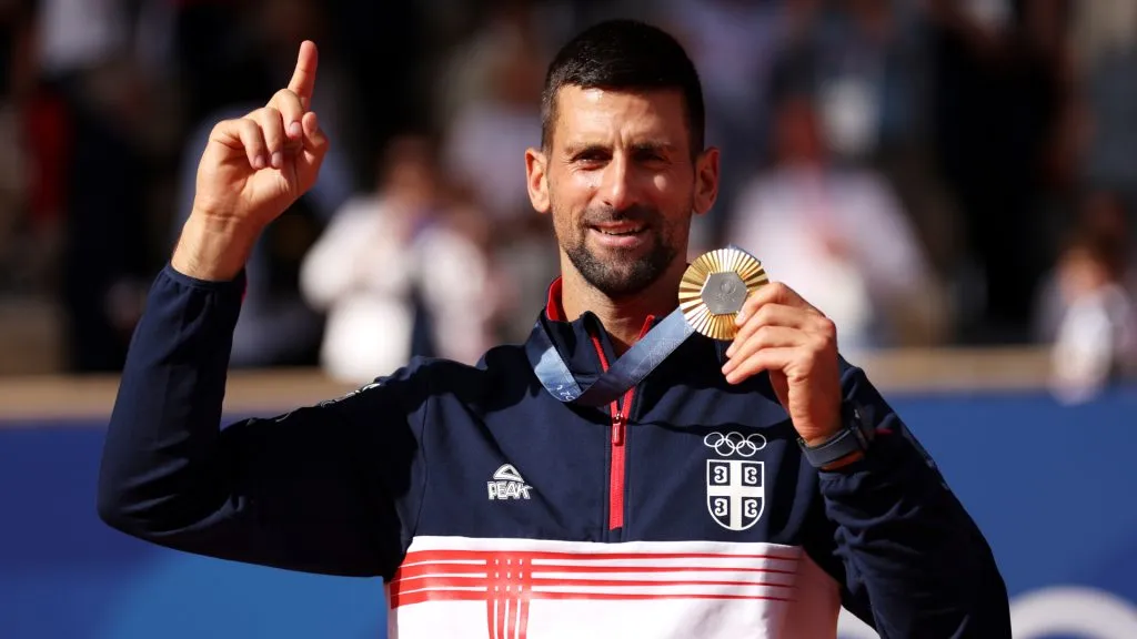 Gold medalist Novak Djokovic of Team Serbia celebrates on the podium. (Clive Brunskill/Getty Images)