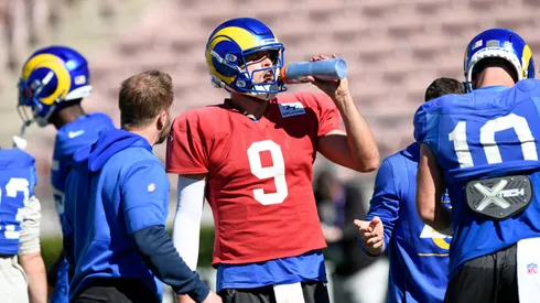 Quarterback Matthew Stafford #9 of the Los Angeles Rams takes a water break as head coach Sean McVay looks on during practice in preparation for Super Bowl LVI in 2022.
