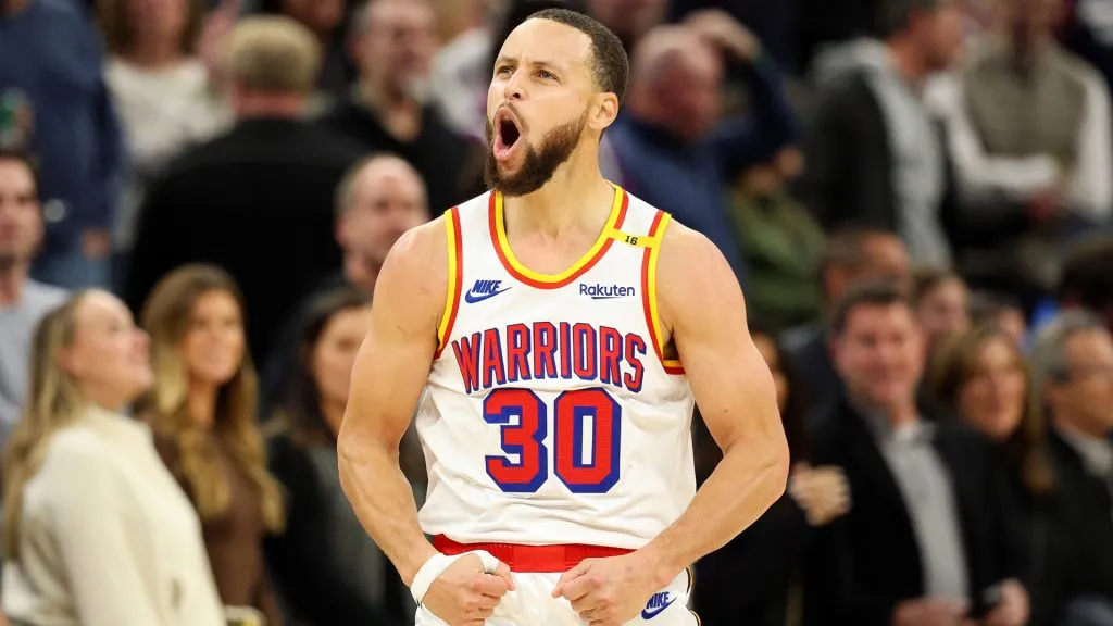 Stephen Curry #30 of the Golden State Warriors celebrates his three-point basket against the Minnesota Timberwolves in the fourth quarter at Target Center.