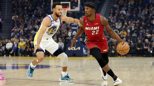 Jimmy Butler #22 of the Miami Heat is guarded by Stephen Curry #30 of the Golden State Warriors at Chase Center on October 27, 2022 in San Francisco, California.