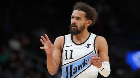 Trae Young #11 of the Atlanta Hawks reacts after drawing a foul on a three-point basket against the Houston Rockets.