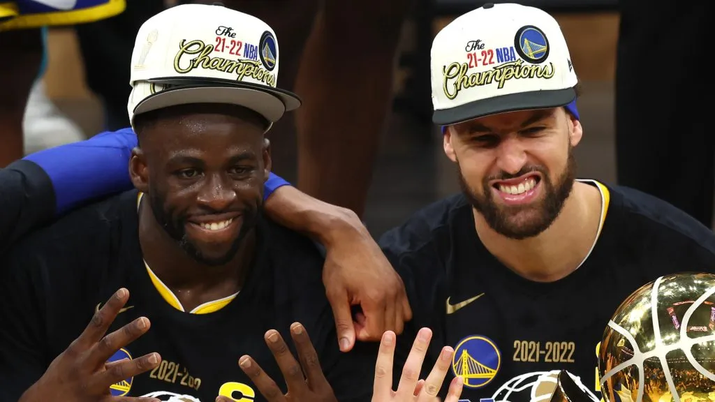 Andre Iguodala #9, Draymond Green #23, Klay Thompson #11 and Stephen Curry #30 of the Golden State Warriors pose for a photo after defeating the Boston Celtics