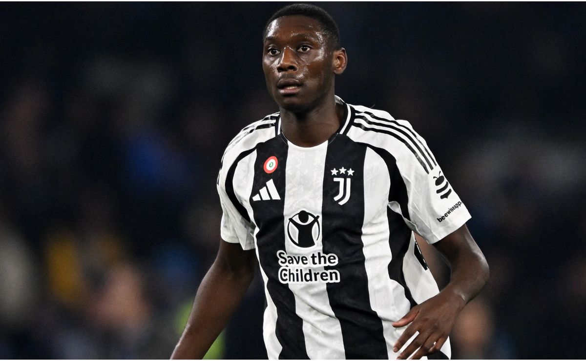 Randal Kolo Muani posing in the Juventus home shirt