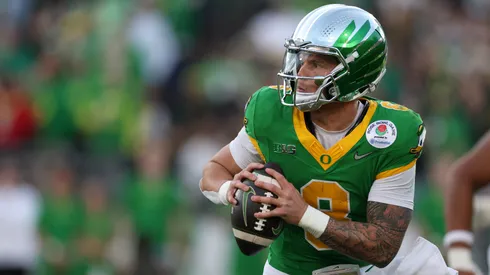 Dillon Gabriel #8 of the Oregon Ducks scrambles with the ball during the Rose Bowl game against the Ohio State Buckeyes at Rose Bowl Stadium on January 01, 2025 in Pasadena, California.