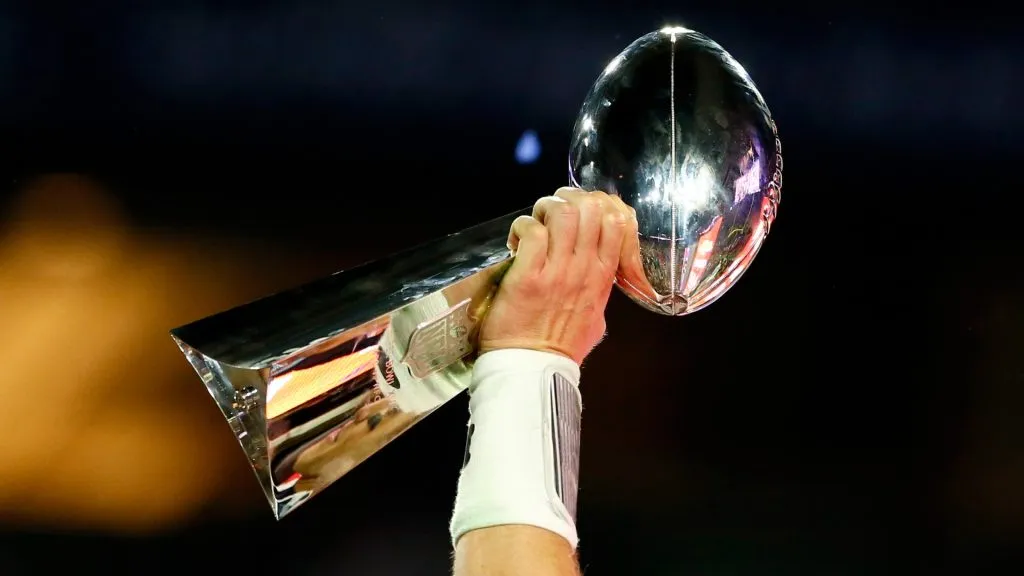 Tom Brady #12 of the New England Patriots celebrates holding the Vince Lombardi Trophy after defeating the Seattle Seahawks during Super Bowl XLIX in 2015. (Source: Kevin C. Cox/Getty Images)