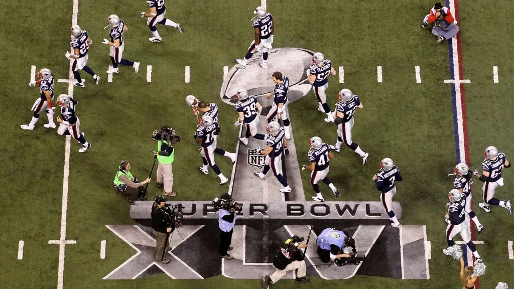 Quarterback Tom Brady #12 of the New England Patriots walks on the field with his teammates prior to Super Bowl XLVI. (Source: Andy Lyons/Getty Images)
