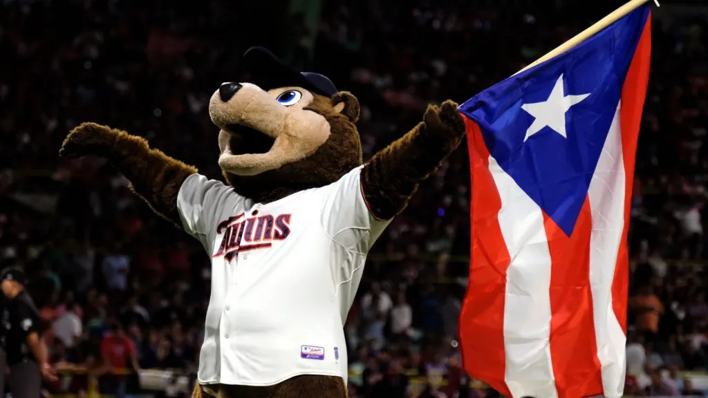 Minnesota Twins mascot TC Bear carries the Puerto Rican flag before the start of a game against the Cleveland Indians at Hiram Bithorn Stadium on April 18, 2018. (Source: Ricardo Arduengo/Getty Images)